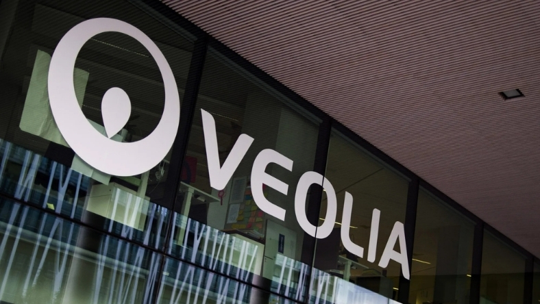Veolia logo displayed on glass facade of corporate office building